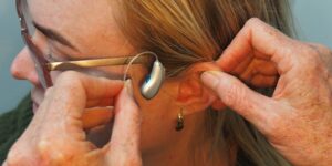 a woman is putting on a pair of glasses