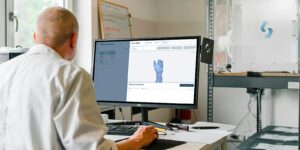 man in white dress shirt sitting in front of computer